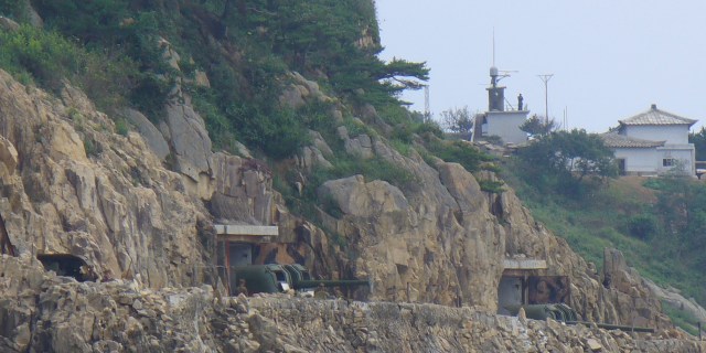 Turrets positioned on a cliff face the Yellow Sea, also known as the Sea of Japan Turrets positioned on a cliff face the Yellow Sea, also known as the Sea of Japan