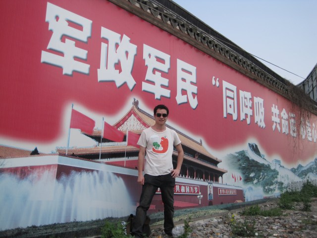Me in front of propaganda pastered across a wall outside of Xitang, a watertown in Zhejiang Province, China Me in front of propaganda pastered across a wall outside of Xitang, a watertown in Zhejiang Province, China