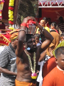 Man carrying milk pots