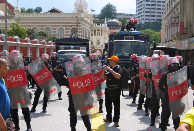 Riot police suited up and ready next to Merdeka Square